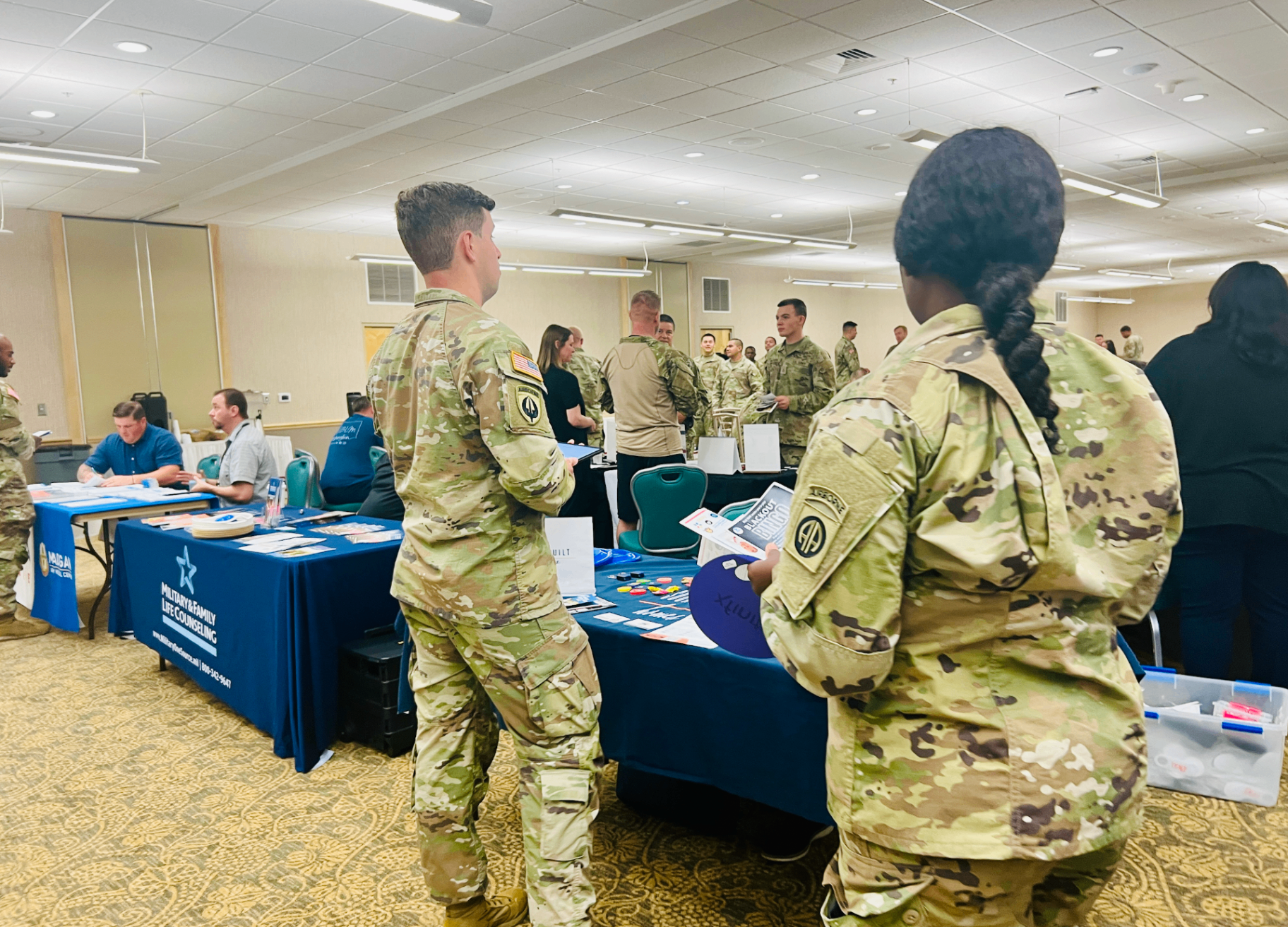 Soldiers at an on-base military and family resource fair, featured in a guide to whether it is cheaper to buy diapers on base.