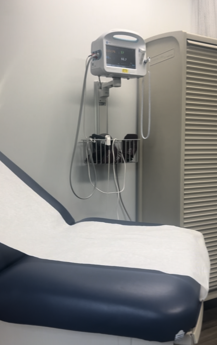 A military medical exam room with a vital-signs monitor, featured in a guide to whether the military and TRICARE pay for diapers.