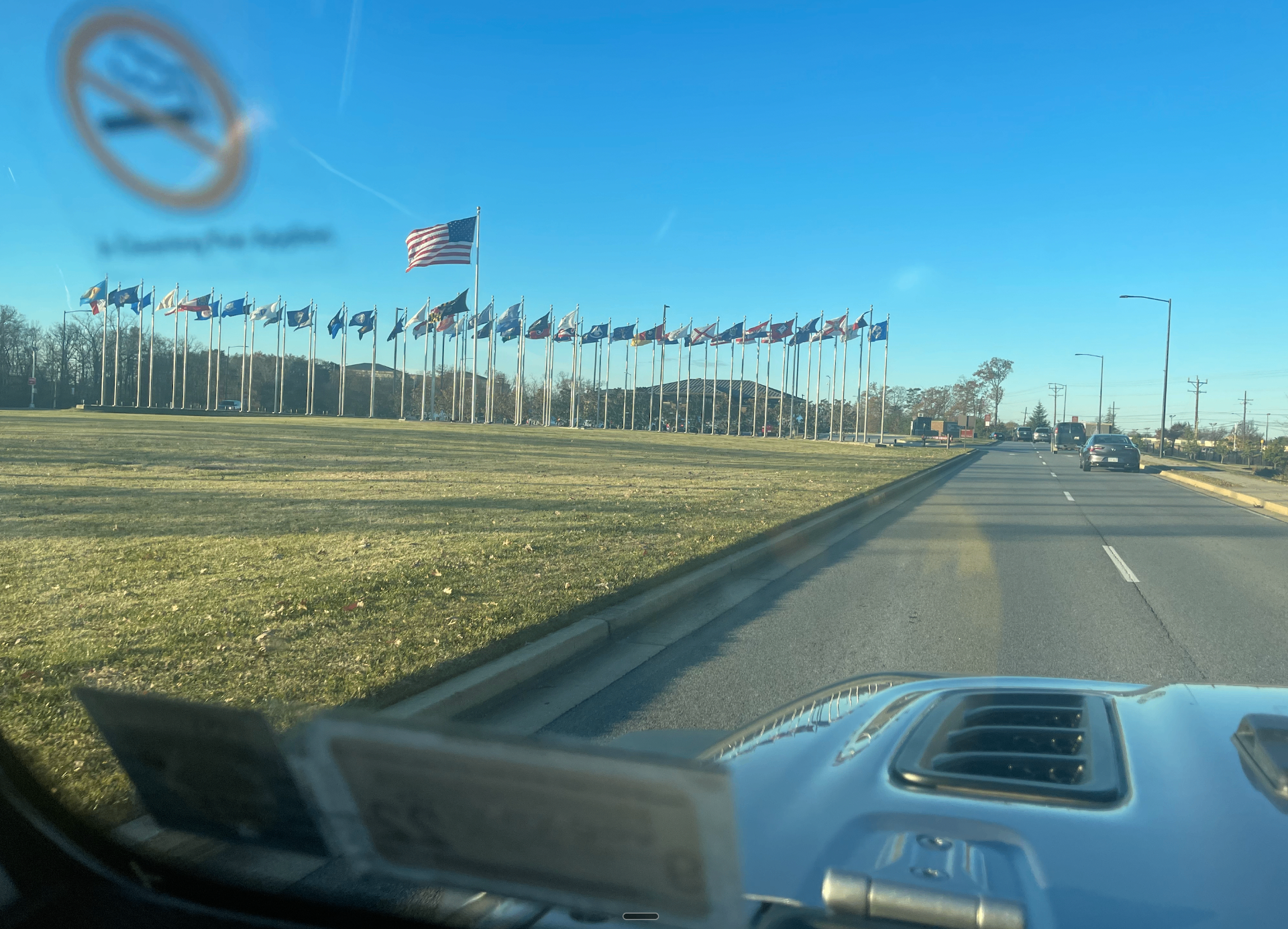 A row of U.S. state flags seen from a rental car after arriving at a new duty station, featured in a guide to using WIC after a PCS to a new state.