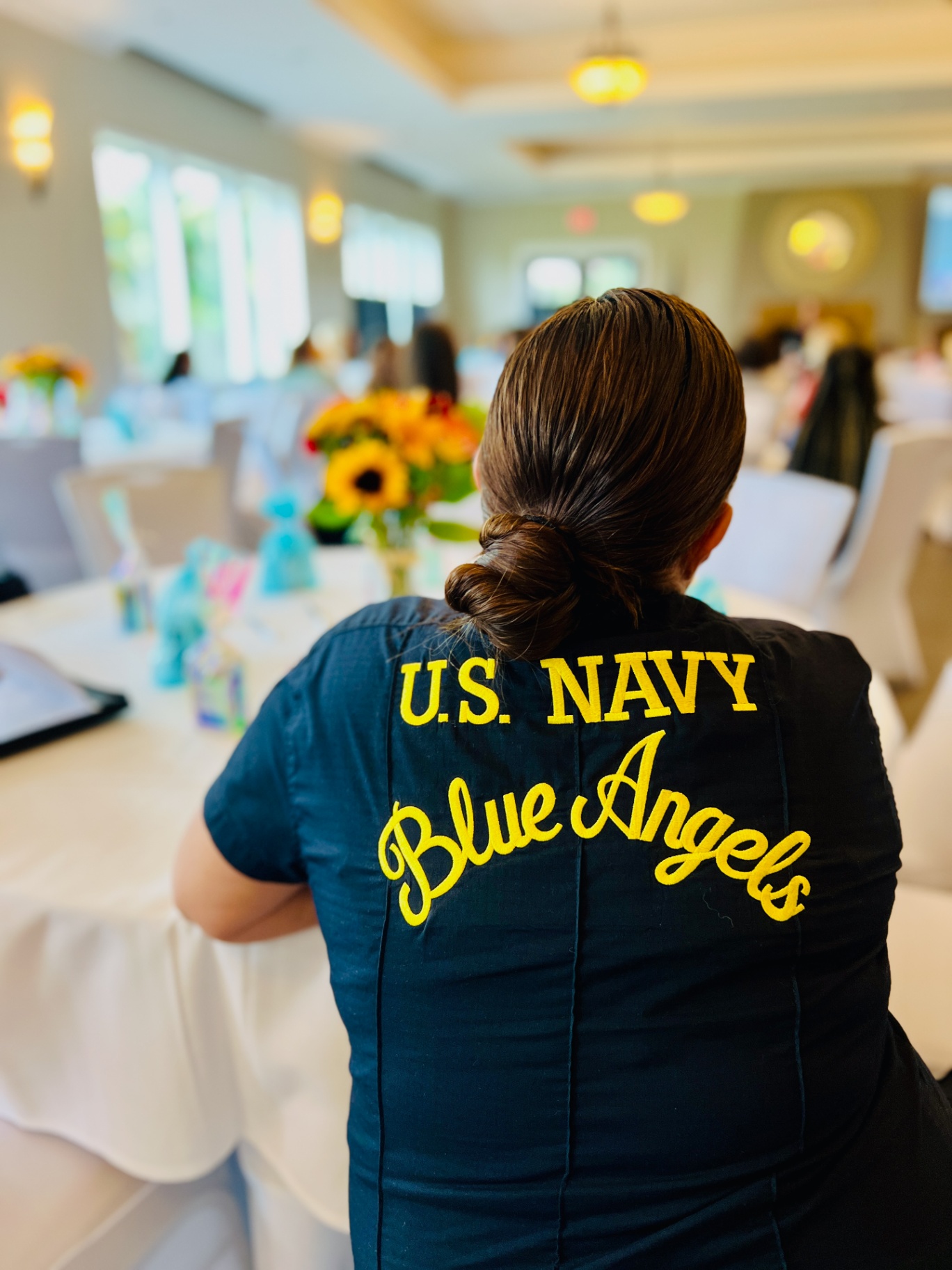 A U.S. Navy Blue Angels jacket at a military family event, featured in a guide to Navy family support.
